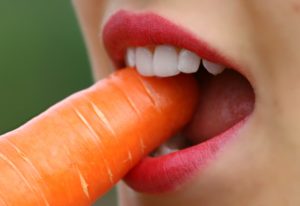 woman eating carrot 